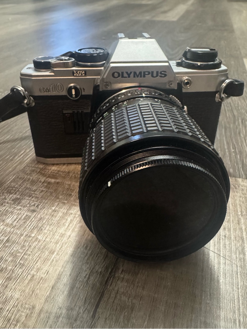 Olympus OM-10 35mm SLR Camera in Silver and Black with Telephoto Lens